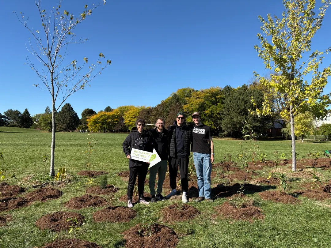 Staccato team standing with freshly planted trees